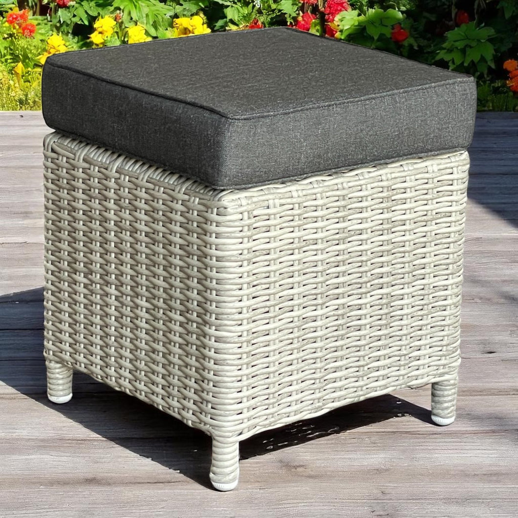 ARMADALE grey wicker ottoman with a dark cushion on a wooden deck - DECOR STAR