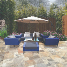 BOX HILL outdoor patio set with blue fabric chairs, lounge sofa and ottoman on a stone patio - DECOR STAR