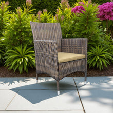Wicker chair with a yellow cushion on a patio - DECOR STAR