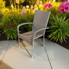 Wicker stacking chair on a patio with flowers and plants in the background - DECOR STAR