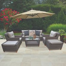 DONCASTER outdoor wicker patio set with grey cushions, and a glasstop coffee table on a stone patio - DECOR STAR