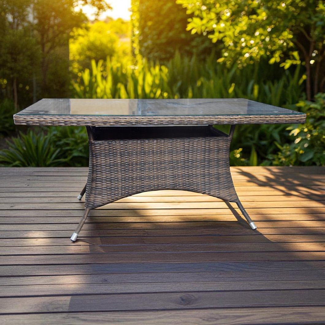 Outdoor patio table with wicker base and glass top on a wooden deck - DECOR STAR