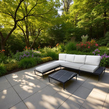 CHELSEA white cushions outdoor sectional sofa with black coffee table on a patio - DECOR STAR