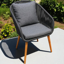 EDITHVALE grey cushioned chair with wooden legs on a patio - DECOR STAR