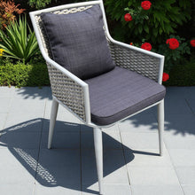 FLEMINGTON white wicker chair with grey cushions on a tiled patio - DECOR STAR