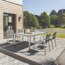 GLENROY outdoor stainless steel frame dining set with cement epoxy table top on a patio - DECOR STAR