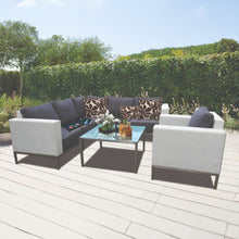 IVANHOE outdoor patio furniture set with a glasstop table on a wooden deck - DECOR STAR