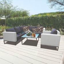 IVANHOE outdoor patio set with sectional sofa and glasstop table on a wooden deck - DECOR STAR