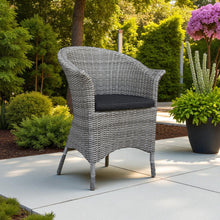 MORDIALLOC wicker chair with a dark cushion on a patio - DECOR STAR