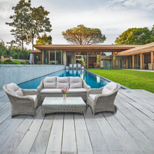 PRAHAN 5-seater outdoor patio set with sofa, chairs, and table on a wooden deck - DECOR STAR