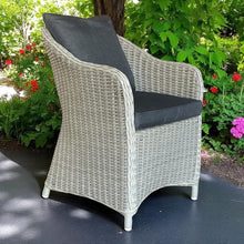 PRESTON grey wicker patio chair with dark cushions on a patio - DECOR STAR