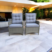 Two grey PE wicker chairs with blue cushions on a patio area - DECOR STAR