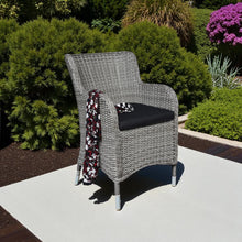 PE wicker chair with black cushion on a patio - DECOR STAR